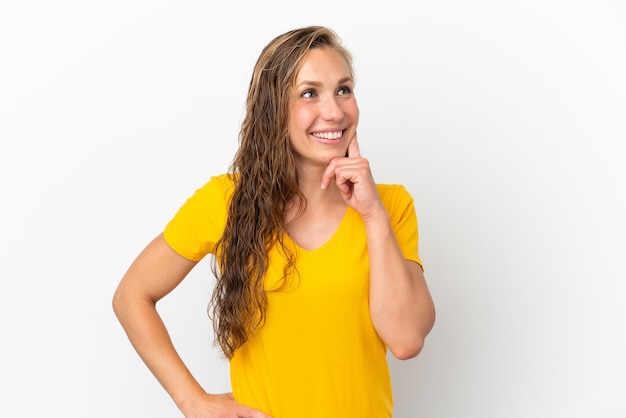 Young caucasian woman isolated on white background thinking an idea while looking up