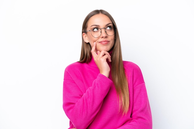 Young caucasian woman isolated on white background thinking an idea while looking up