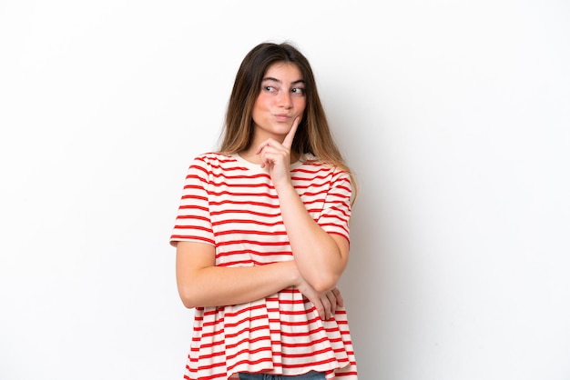 Young caucasian woman isolated on white background and thinking