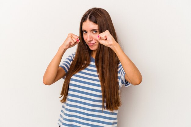 Young caucasian woman isolated on white background throwing a punch, anger, fighting due to an argument, boxing.