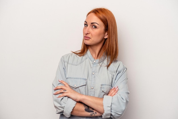 Photo young caucasian woman isolated on white background unhappy looking in camera with sarcastic expression