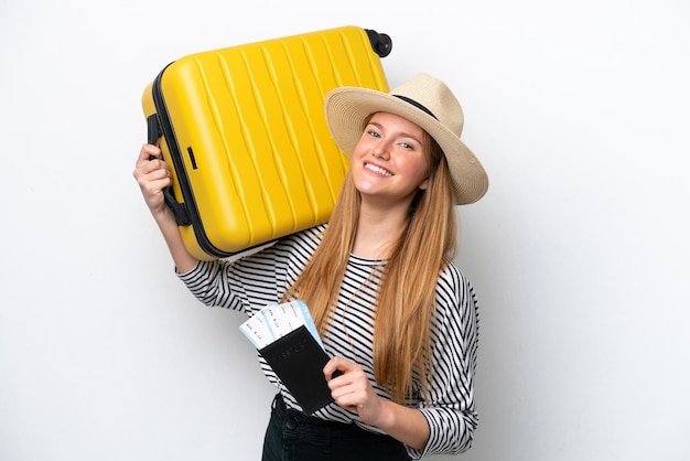 Young caucasian woman isolated on white background in vacation with suitcase and passport