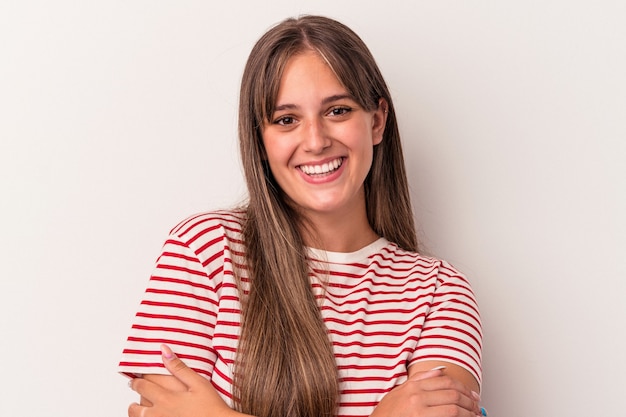 Young caucasian woman isolated on white background who feels confident, crossing arms with determination.