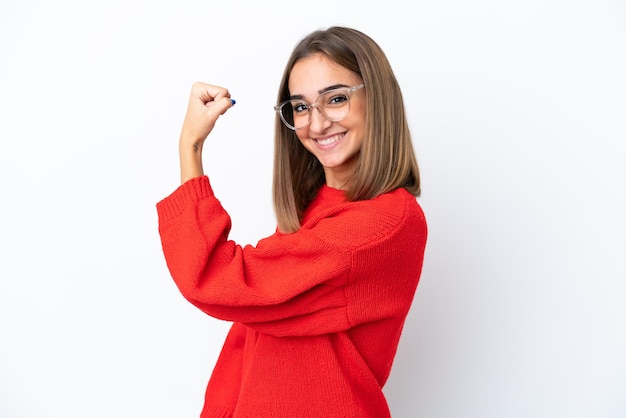 Young caucasian woman isolated on white background With glasses and celebrating a victory