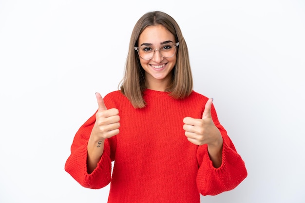 Young caucasian woman isolated on white background With glasses and with thumb up