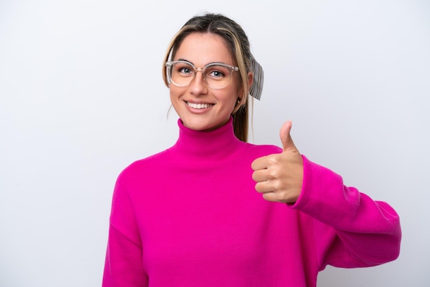 Young caucasian woman isolated on white background With glasses and with thumb up