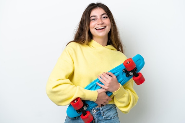 Young caucasian woman isolated on white background with a skate with happy expression