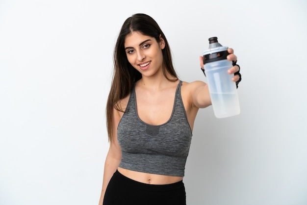 Young caucasian woman isolated on white background with sports water bottle