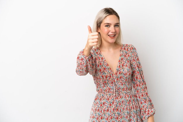 Young caucasian woman isolated on white background with thumbs up because something good has happened