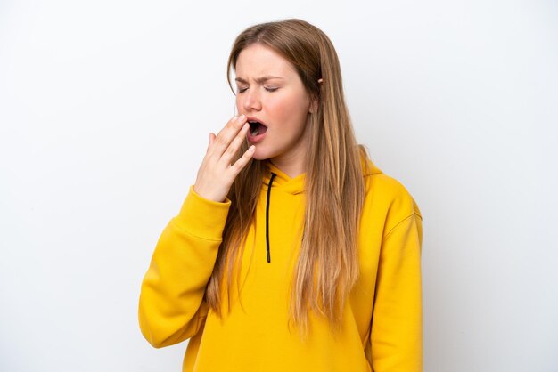 Young caucasian woman isolated on white background yawning and covering wide open mouth with hand