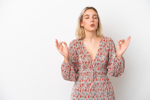 Young caucasian woman isolated on white background in zen pose