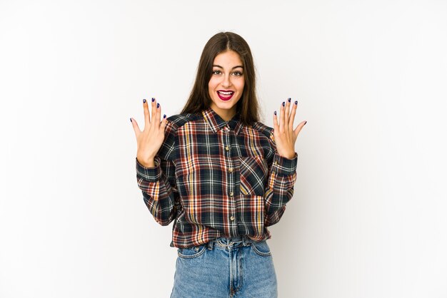 Young caucasian woman isolated on white showing number ton with hands.