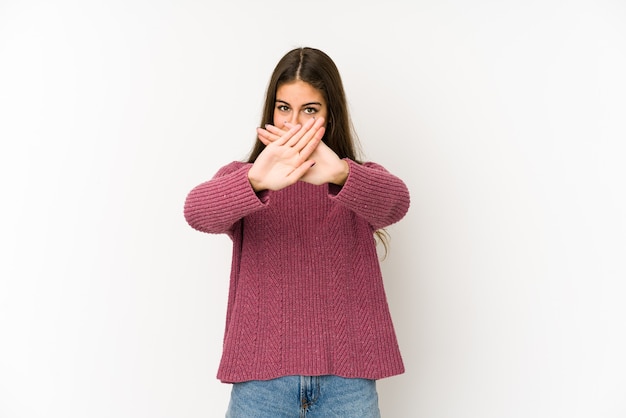 Young caucasian woman isolated on white space doing a denial gesture