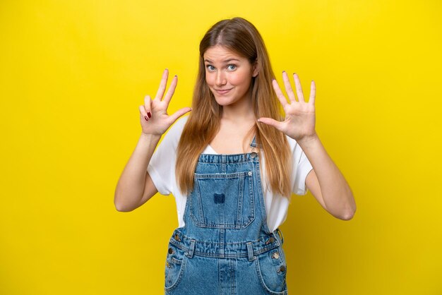 Young caucasian woman isolated on yellow background counting eight with fingers