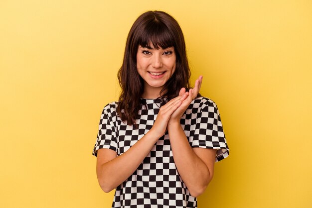 Young caucasian woman isolated on yellow background feeling energetic and comfortable, rubbing hands confident.