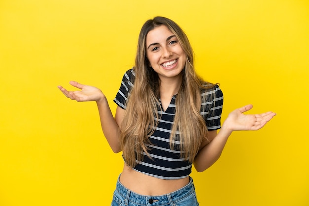 Young caucasian woman isolated on yellow background happy and smiling