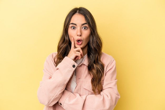 Young caucasian woman isolated on yellow background having some great idea concept of creativity