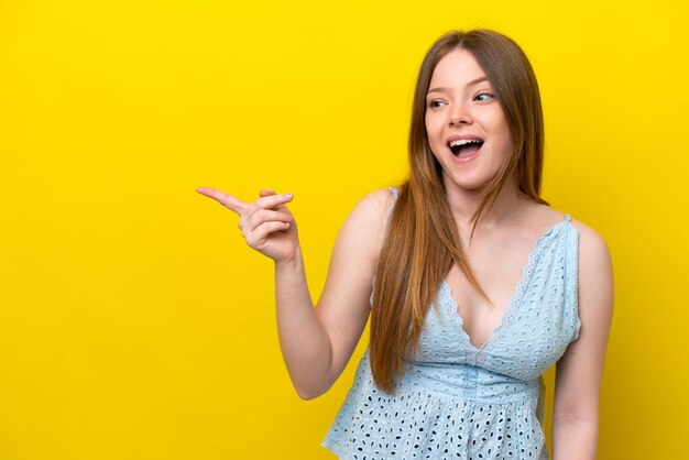 young caucasian woman isolated on yellow background intending to realizes the solution while lifting a finger up