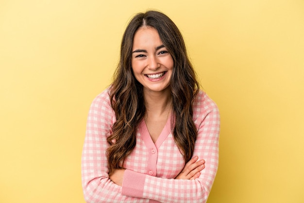 Young caucasian woman isolated on yellow background laughing and having fun