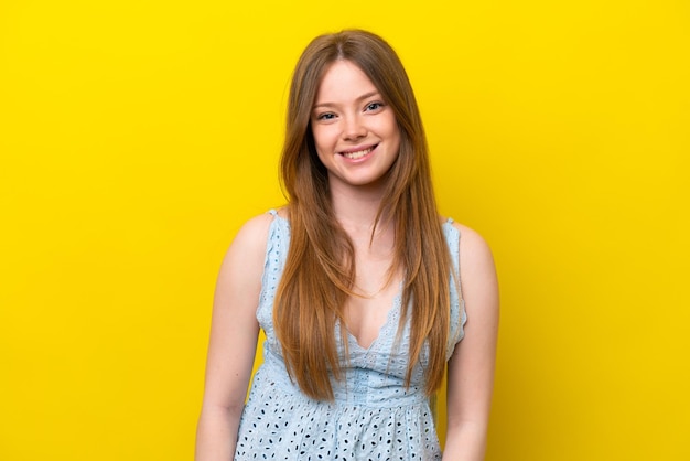 Young caucasian woman isolated on yellow background laughing