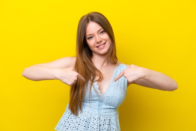 Young caucasian woman isolated on yellow background proud and selfsatisfied