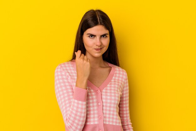 Young caucasian woman isolated on yellow background showing that she has no money.