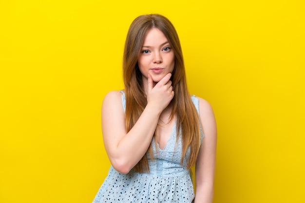 Young caucasian woman isolated on yellow background thinking