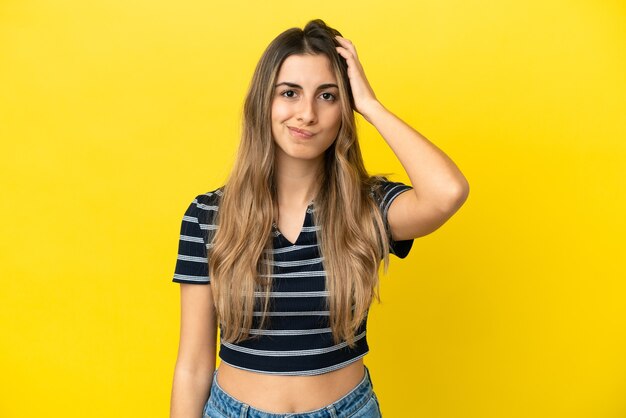 Young caucasian woman isolated on yellow background with an expression of frustration and not understanding