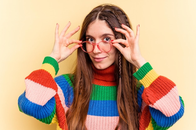 Young caucasian woman isolated on yellow background