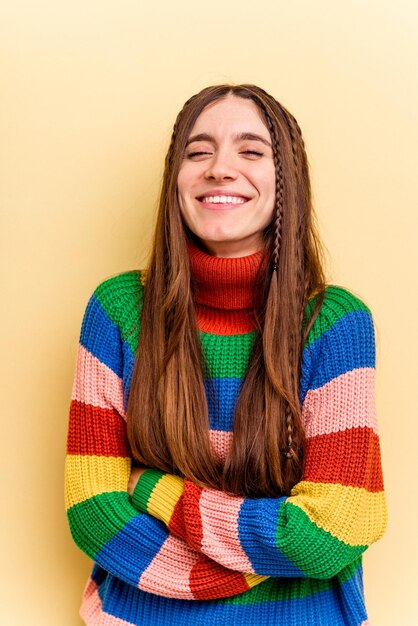 Young caucasian woman isolated on yellow background