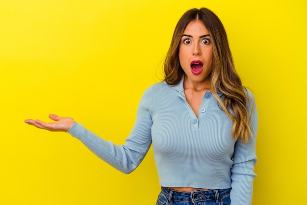 Young caucasian woman isolated on yellow background