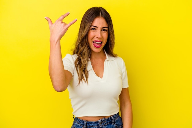 Young caucasian woman isolated on yellow background