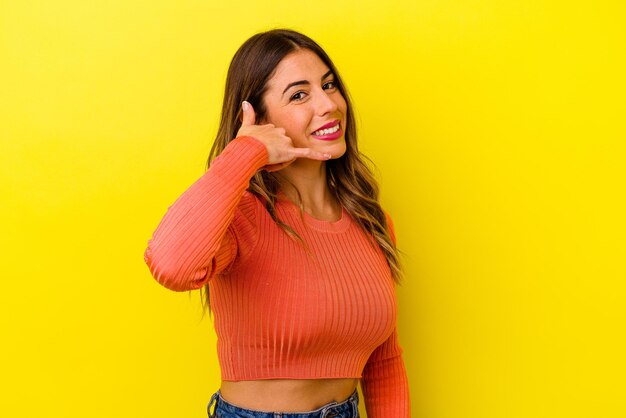 Young caucasian woman isolated on yellow background