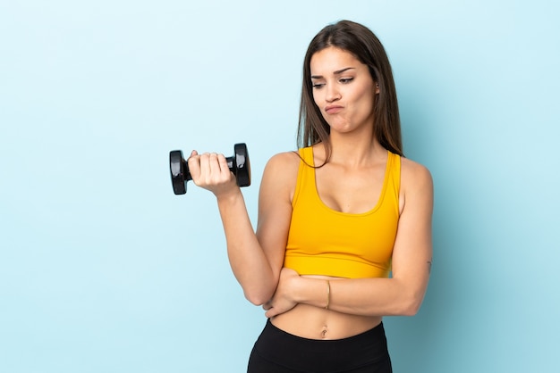 Young caucasian woman making weightlifting