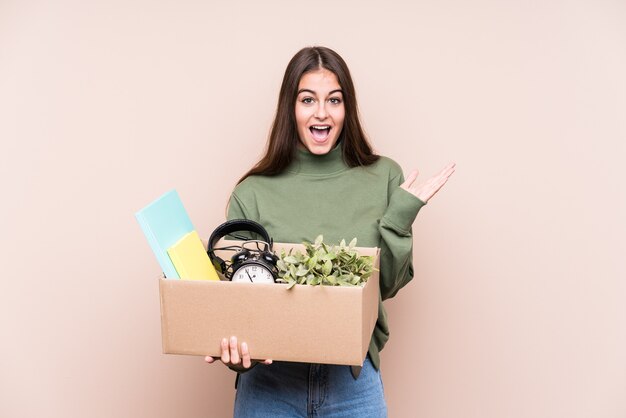 Young caucasian woman moving to a new home isolated surprised and shocked.