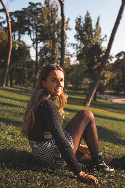 Young caucasian woman at the park wearing a white short and a black shirt. Madrid, Spain.