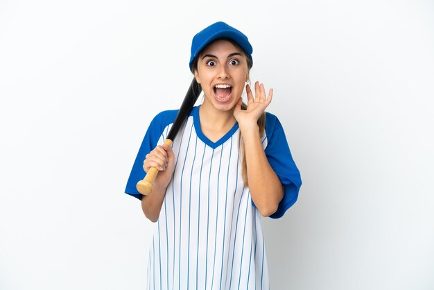 Young caucasian woman playing baseball isolated on white background with surprise and shocked facial expression