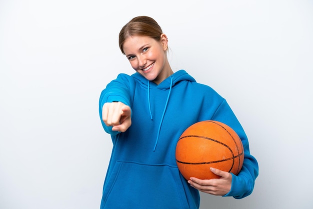 Young caucasian woman playing basketball isolated on white background pointing front with happy expression