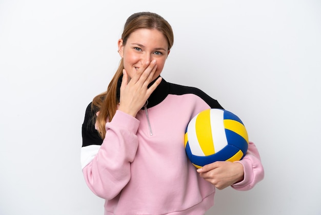 Young caucasian woman playing volleyball isolated on white background happy and smiling covering mouth with hand