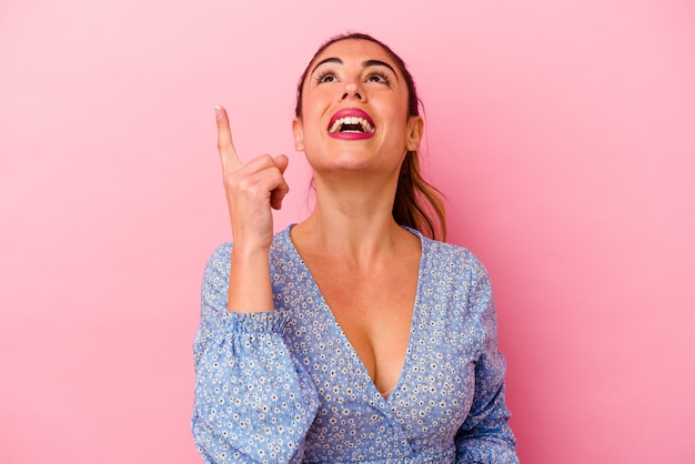 Young caucasian woman pointing up