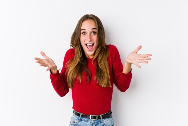 Young caucasian woman posing isolated  celebrating a victory or success, he is surprised and shocked.