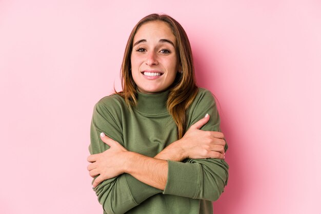 Young caucasian woman posing isolated  going cold due to low temperature or a sickness.