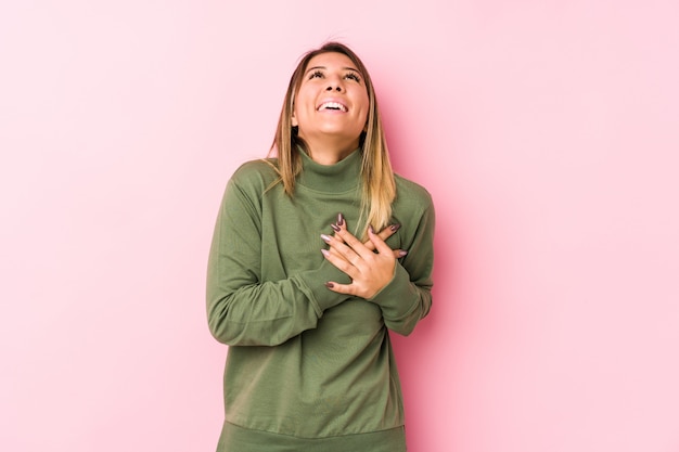 Young caucasian woman posing isolated  laughing keeping hands on heart, concept of happiness.