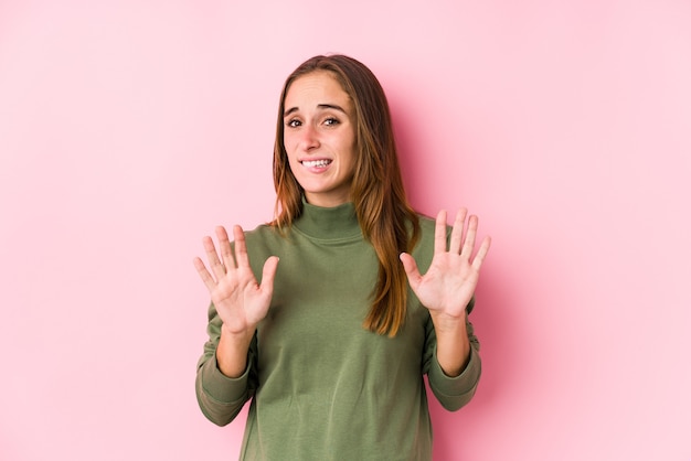 Young caucasian woman posing isolated  rejecting someone showing a gesture of disgust.