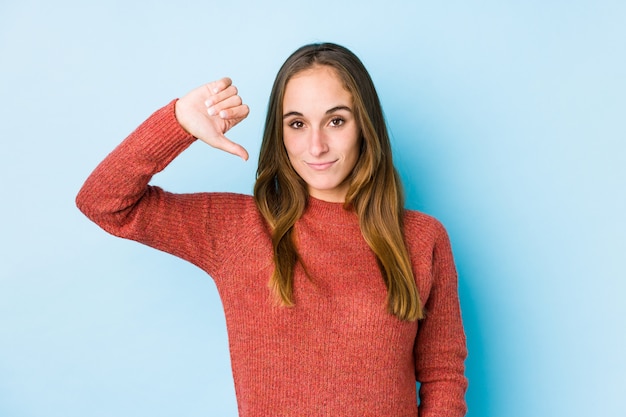 Young caucasian woman posing isolated  showing a dislike gesture, thumbs down. Disagreement concept.