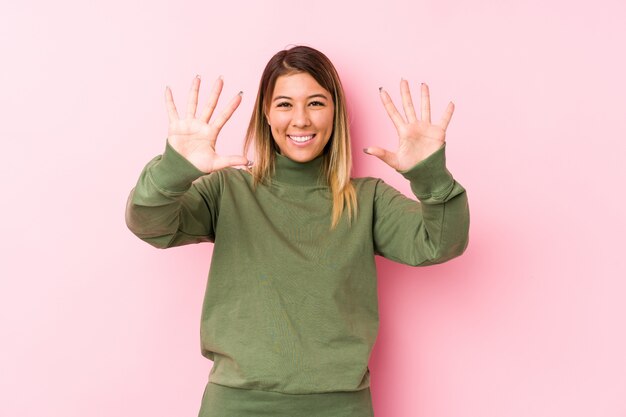 Young caucasian woman posing isolated  showing number ten with hands.