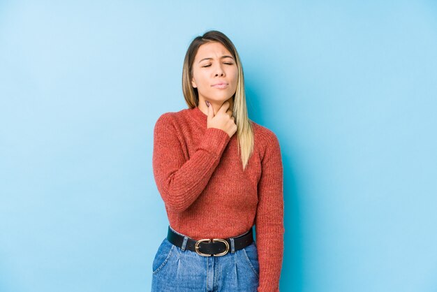 Young caucasian woman posing isolated suffers pain in throat due a virus or infection.