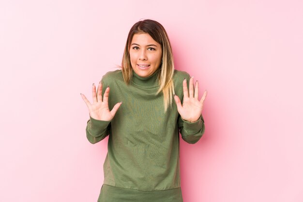 Young caucasian woman posing rejecting someone showing a gesture of disgust.