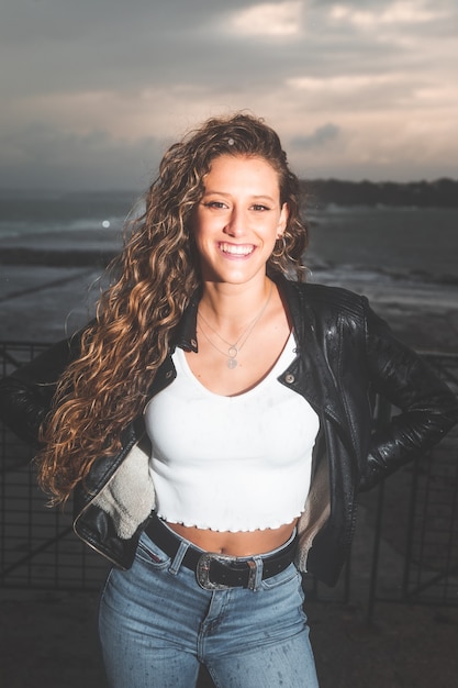 Young caucasian woman posing at a sea port