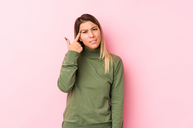 Young caucasian woman posing   showing a disappointment gesture with forefinger.